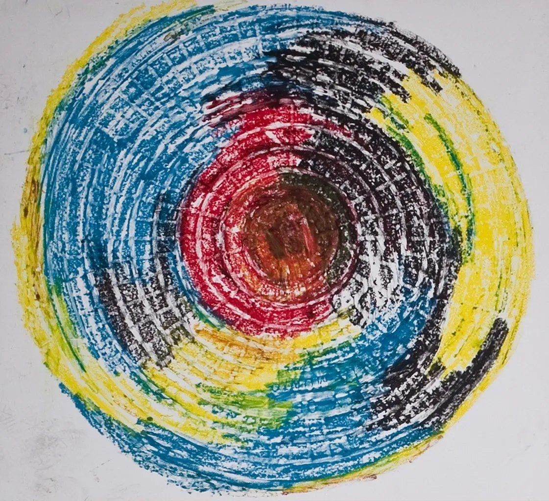 A circular painting of a red, yellow and blue circle.