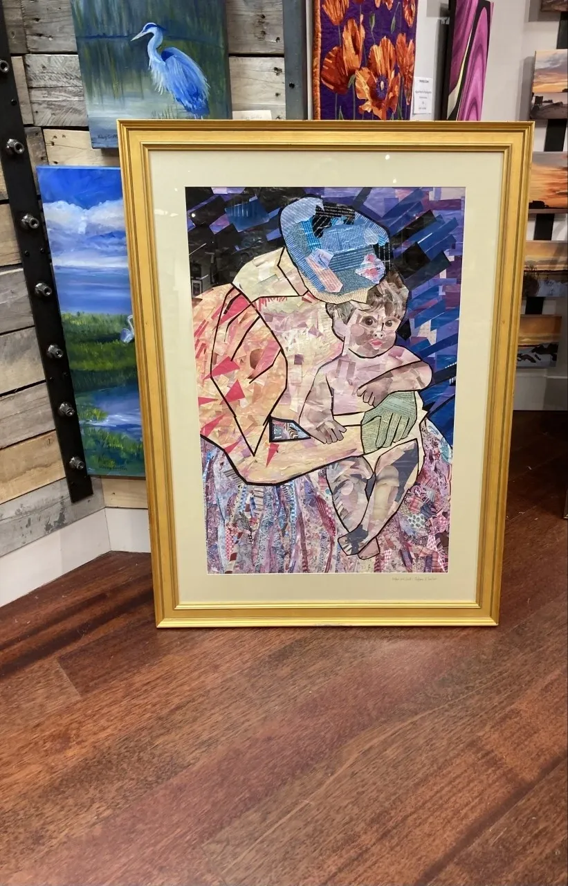 A painting of a woman and child in a frame.