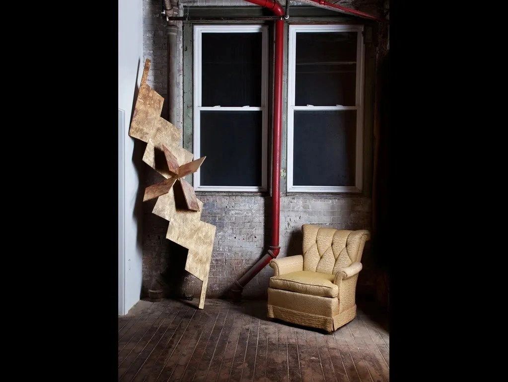 A chair and some stairs in front of a window.