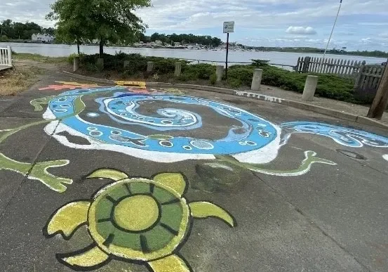 A turtle and other shapes painted on the ground.
